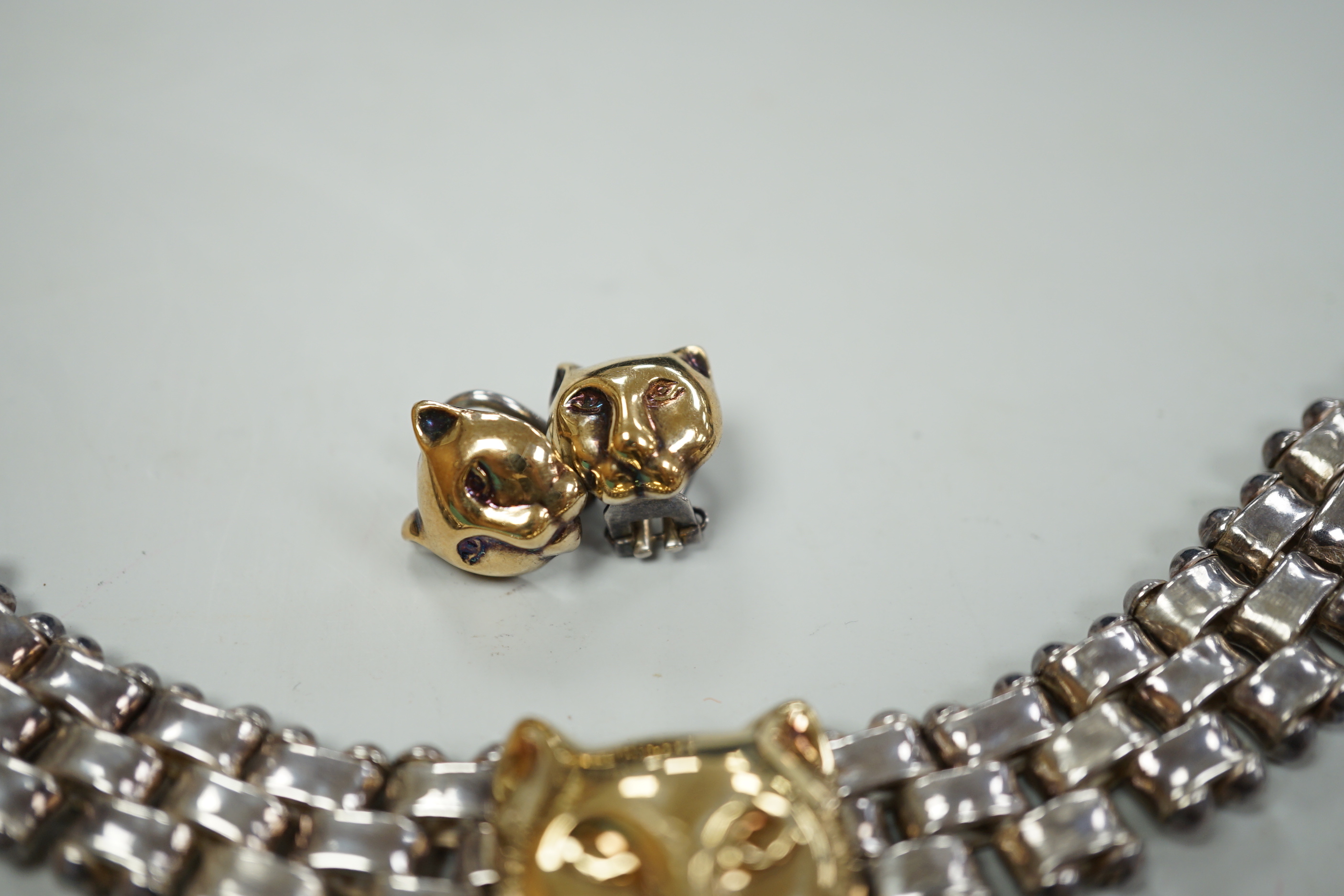 A modern Italian silver and 750 yellow metal necklace and pair of matching earrings, with leopard's head motif, necklace, 40cm.